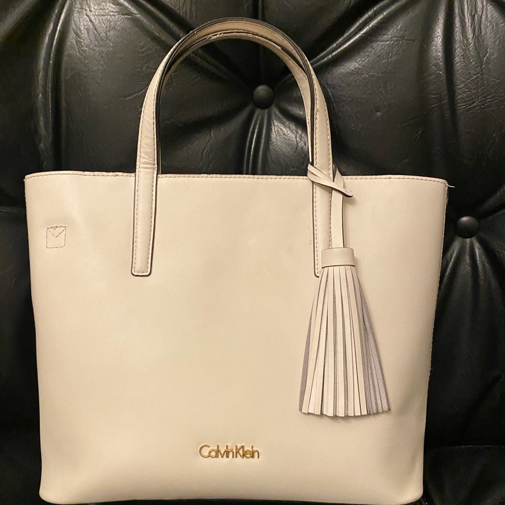 Off white Calvin K. Tote with cross body strap.